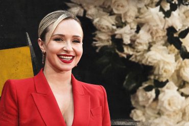 Hayden Panettiere smiling in a red suit at a red-carpet event