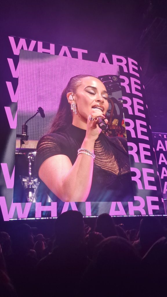 Jorja Smith performing in front of What Are The Odds visuals during her All Points East headline set