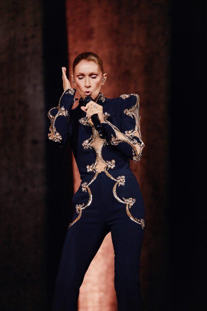 Céline Dion sings in a dark embellished trouser suit during her Paris 2026 concert
