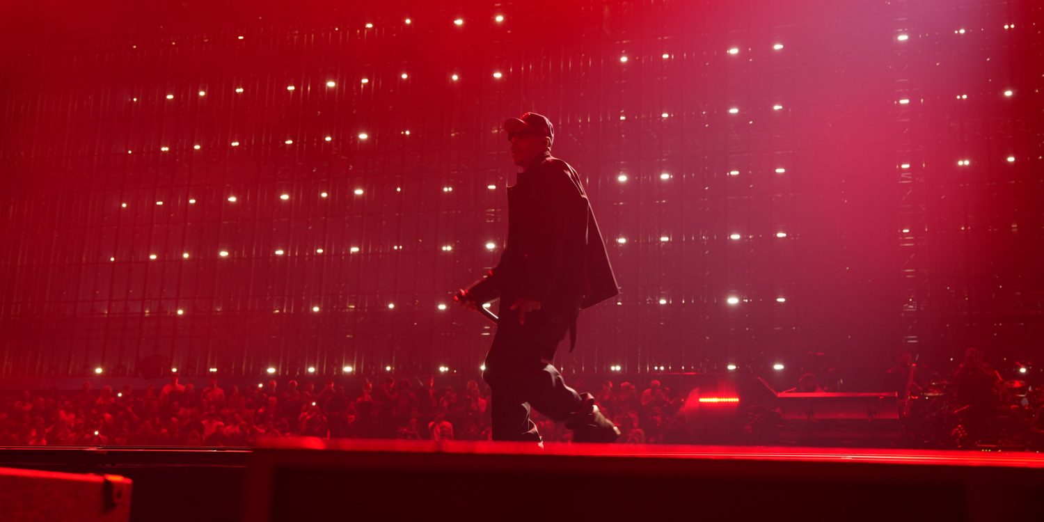 JAY-Z performing during JAY-Z 30 London at Tottenham Hotspur Stadium under red stage lighting