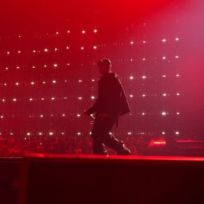 JAY-Z performing during JAY-Z 30 London at Tottenham Hotspur Stadium under red stage lighting