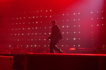 JAY-Z performing during JAY-Z 30 London at Tottenham Hotspur Stadium under red stage lighting