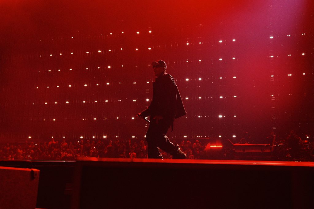 JAY-Z performing during JAY-Z 30 London at Tottenham Hotspur Stadium under red stage lighting