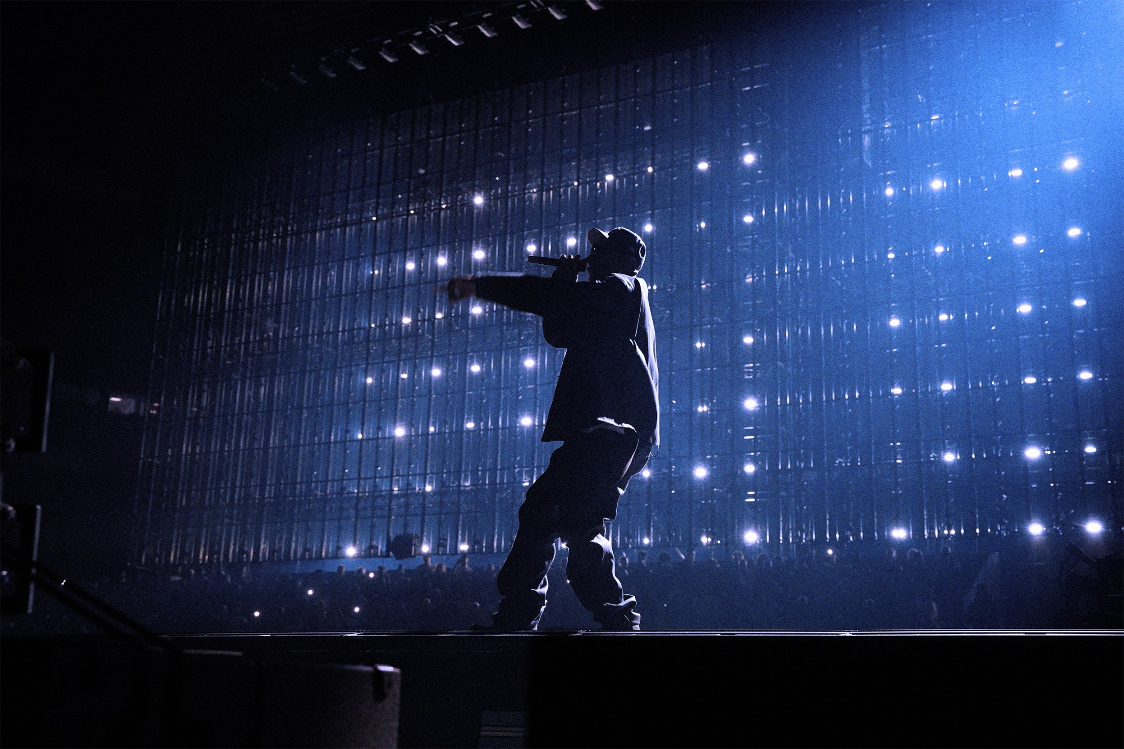 JAY-Z performing during JAY-Z 30 at Tottenham Hotspur Stadium in London against a lit stage backdrop