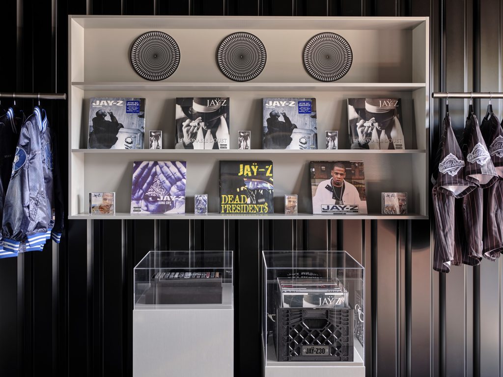 Interior of the JAŸ-Z 30 Trafalgar Square London pop-up store displaying clothing, caps and merchandise