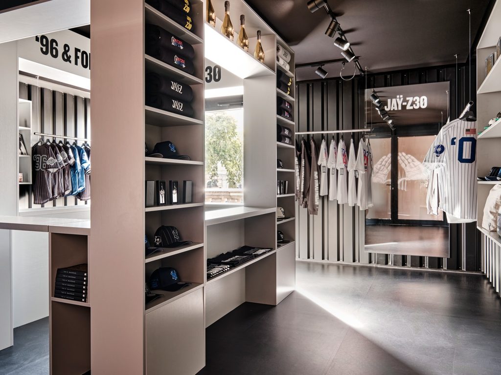 Interior of the JAŸ-Z 30 Trafalgar Square London pop-up store displaying clothing, caps and merchandise