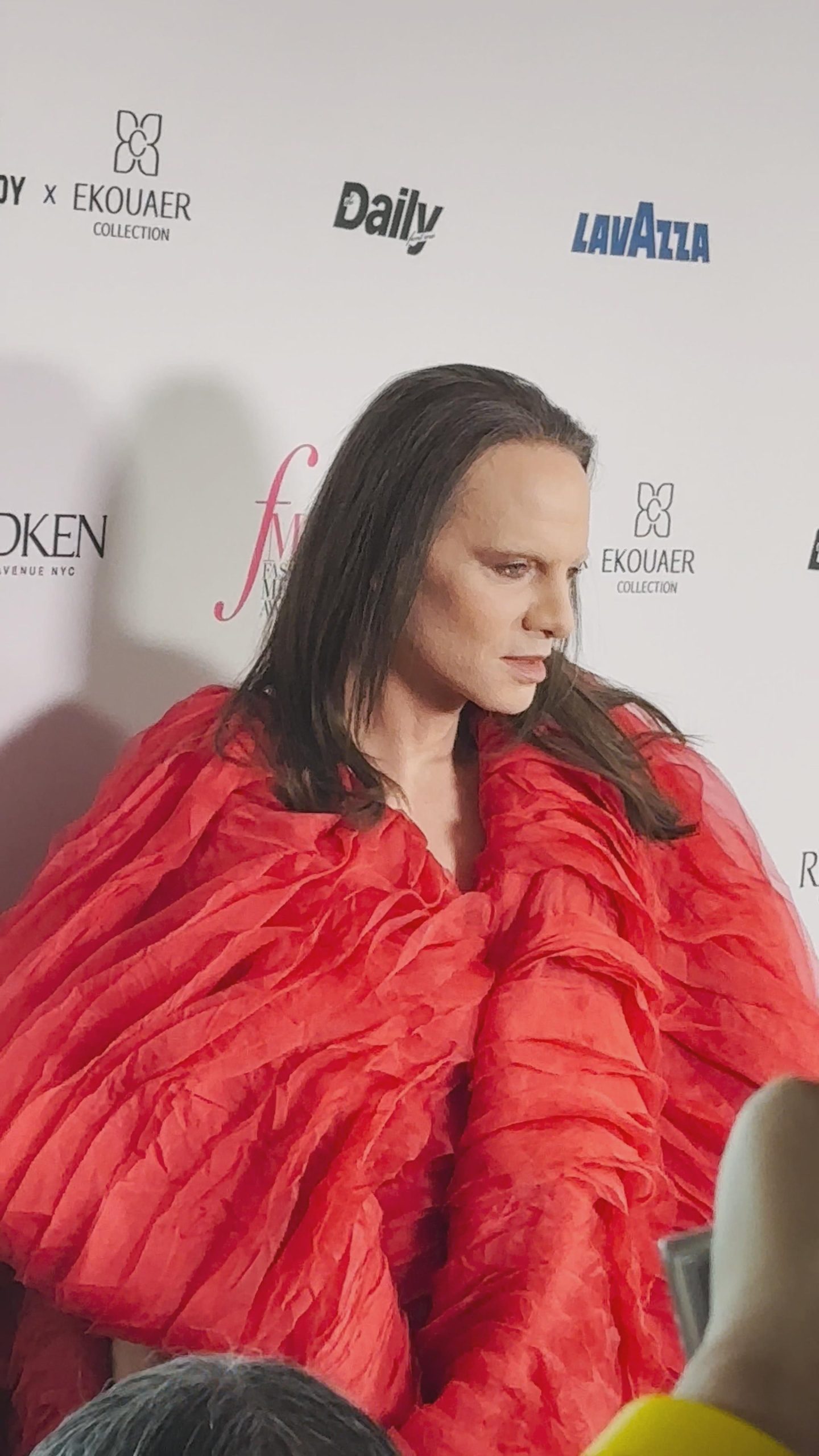 Jordan Roth wearing a sculptural red outfit at the 2026 Fashion Media Awards during NYFW